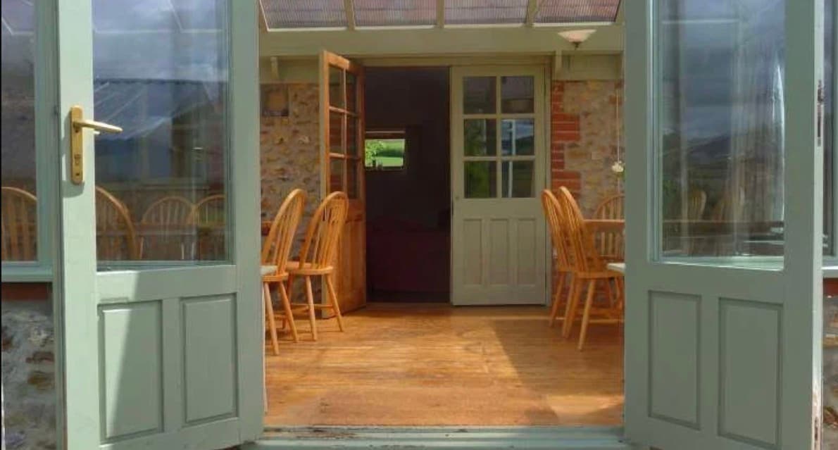 The light-filled dining room opening onto the gardens